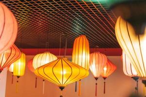 Colorful Chinese lanterns lamps on ceiling textured background photo