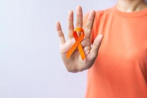 cinta naranja para la leucemia, día del cáncer de riñón, esclerosis múltiple mundial, crps, mes de concientización sobre las autolesiones. cuidado de la salud y el concepto del día del cáncer de palabra foto