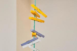 Multi-colored plastic clothespins on a rope, background for advertising. Recycle materials for reuse, second life photo