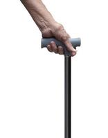 Senior hand holding a walking stick or a cane, isolated on white background. Medical and healthcare concept. Forehand side. photo