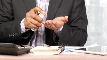 Close Up Of Young Man Hand Using Hand Sanitizer Spray At Work video