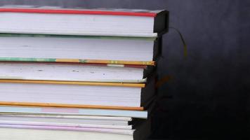 Stack of books on table with copy space video