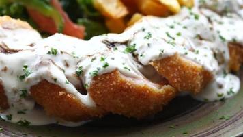 Close up of chicken stripe and sauce on table video