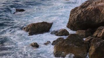 mare onde Crashing su rocce su il costa, natura metraggio 4k. video