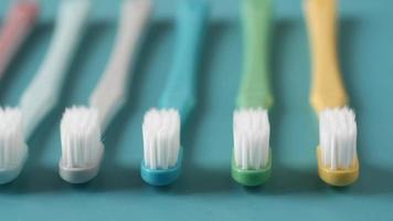 Colorful Toothbrushes On A Light Green Background video