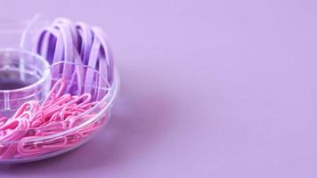 Colorful Paper Clip Dropping On Pink Background