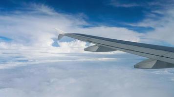 Airplane flight. Wing of an airplane flying above the clouds. View from the window of the plane video