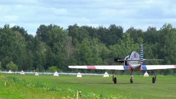 NOVOSIBIRSK, RUSSIAN FEDERATION AUGUST 5, 2018 - Sport airplane taxiing on green grassy airfield video