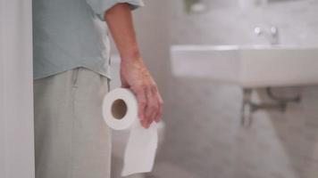 A man feeling his stomach with abdominal pain and use hand open the toilet lid. Men have diarrhea after waking up in the morning. Health concepts for diarrhea and gastritis.
