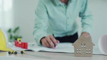 Engineers recheck house design for pre-construction. The construction contractor is reading the design of the house where corrections need to be made. House design and inspection concept. video