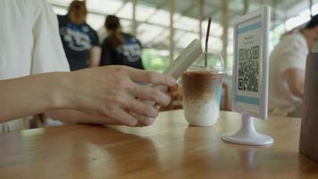 Woman use smartphone to scan QR code in cafe. The restaurant and hotel built a digital payment system without cash. Qr code pay, E wallet, cash technology, pay online video