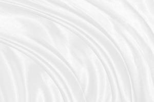 Smooth elegant white silk or satin luxury cloth texture can use as wedding background. Luxurious background design photo