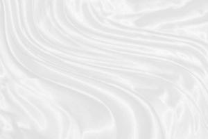 Smooth elegant white silk or satin luxury cloth texture can use as wedding background. Luxurious background design photo