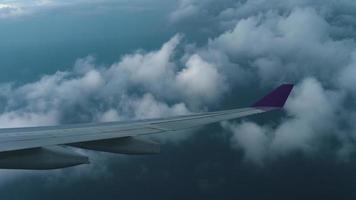 la vista desde la cabina del avión descendiendo a través de las nubes antes de aterrizar en el aeropuerto de phuket, tailandia