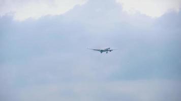 aereo di linea si avvicina approdo. il aereo è volante alto nel il grigio nuvoloso cielo. aereo atterraggio video