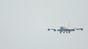 Ein ziviles Flugzeug fliegt am grauen Himmel und nähert sich der Landung. Ankunftsflug zur tropischen Insel Phuket video