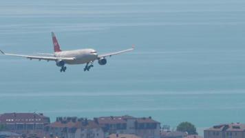 SOCHI, RUSSIA JULY 29, 2022 - Civil plane Airbus A330 of Nordwind descending before landing at Sochi Airport. Airplane flies on the sea. Tourism and travel concept video