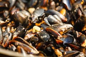 Appetizer stuffed mussels. Street vendor sells mussels with a squirt of lemon juice photo