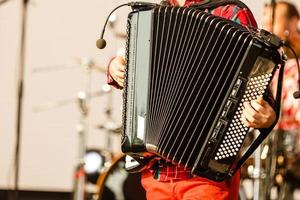 Male playing on the accordion against a grunge background photo