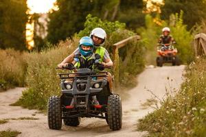 little boy with instructor on a quad bike photo