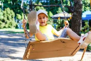Little girl on the swing. photo