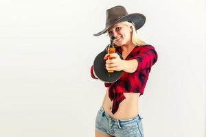 The sexy blonde woman with a hat woman cowboy on a white background photo