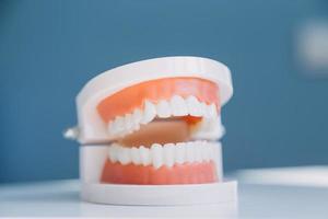 Stomatology concept, partial portrait of girl with strong white teeth looking at camera and smiling, fingers near face. Closeup of young woman at dentist's, studio, indoors photo