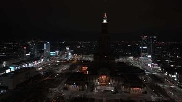 Aerial night view of the Palace of Culture and Science near downtown business skyscrapers in the city center. video