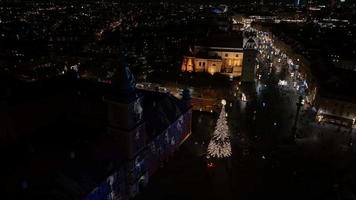 Aerial Christmas night of the Warsaw old town. Beautiful illuminated Christmas tree in the middle of the city. video