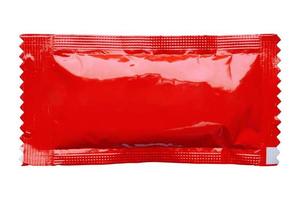 Blank red foil tomato ketchup sauce sachet package isolated on white background photo