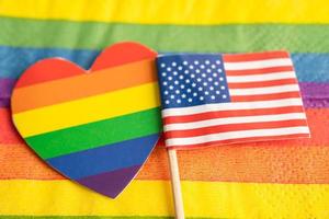 USA America flag on rainbow background symbol of LGBT gay pride month  social movement rainbow flag is a symbol of lesbian, gay, bisexual, transgender, human rights, tolerance and peace. photo