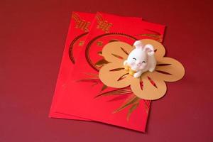 Chinese New Year of the rabbit festival concept. Rabbit on red envelopes isolated on red background. Happy New Year Chinese Rabbit 2023. photo