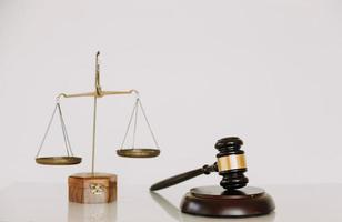 Business and lawyers discussing contract papers with brass scale on desk in office. Law, legal services, advice, justice and law concept photo