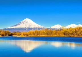 Koriakski volcano in autumn evening with reflection on the lake. Kamchatka peninsula photo