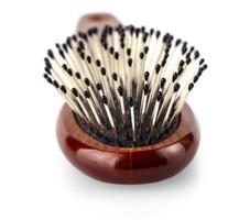 Wooden hairbrush on white background. photo