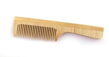 the wooden comb for hair on a white background photo