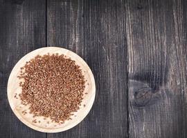 The Flax seeds in a wooden plate photo