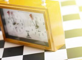 classic, mechanical chess clock on wooden chess board photo