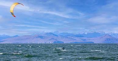 Kitesurfing on the waves in the Pacific Ocean off the coast of the Kamchatka Peninsula photo