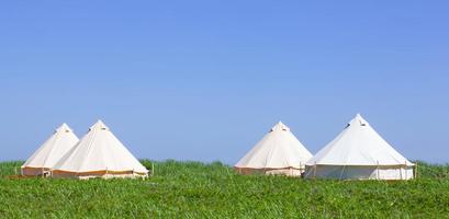 Glamping house in the nature. Blue sky fnd green grass. photo