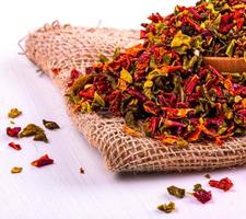 Colored spices with pepper in a cup and burlap photo