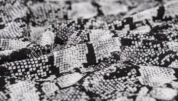 Black and white abstract camouflage. The concealment pattern on a fabric. photo