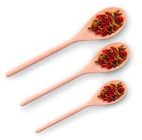 three wooden spoons with spices on a white background photo