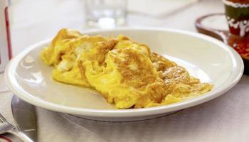 Delicious fresh omelet on a white plate. Selective focus photo