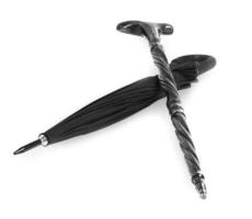 wooden cane and black umbrella lying horizontally on a white background photo