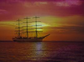 Sailing ship in the sea on sunset. Selective focus photo