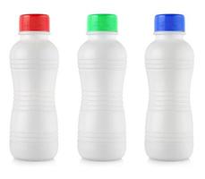 Opaque white plastic bottles with colored lidon white background photo