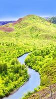 The Fall forest and river with colorful trees and blue sky photo