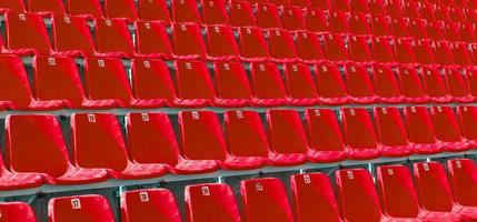 Folded blue plastic chairs on a temporary tribune. photo