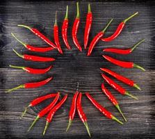 top view of spicy red chili pepper on wooden surface.Selective focus photo